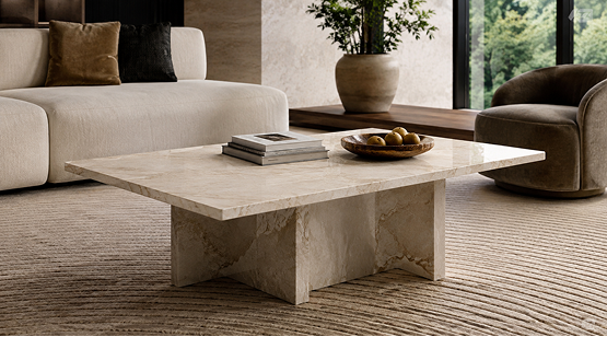 Square low-profile beige stone coffee table styling in a modern living room setting